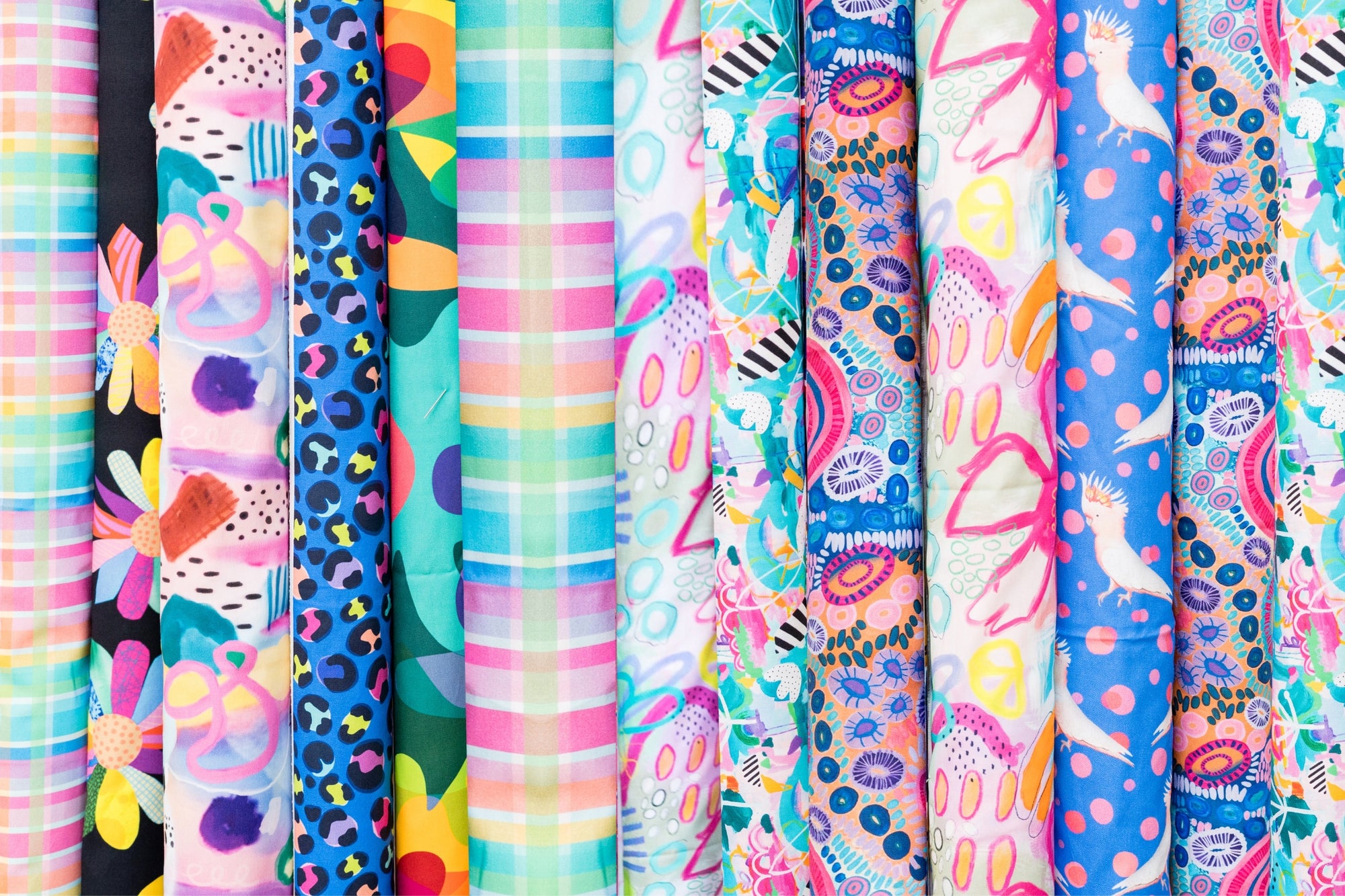 rolls of colourful fabric all lined up